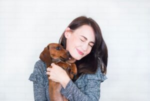 Why Does My Dog Lick Me After Eating? (5 Reasons)